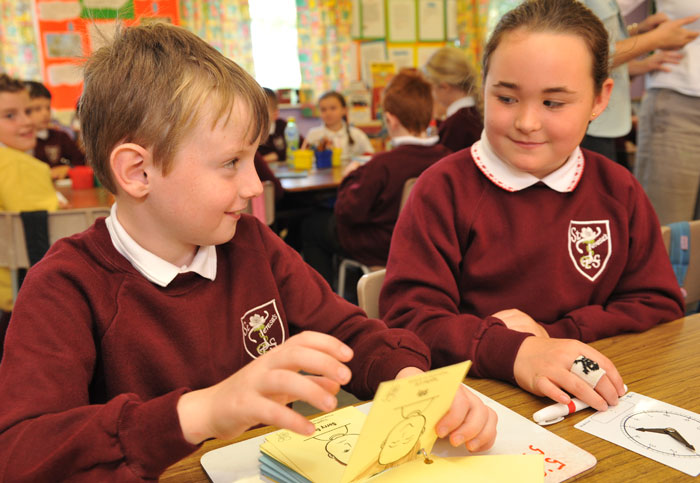 Image showing school children sitting at desk working together